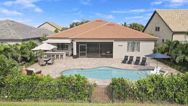 view of pool featuring a sunroom and a patio