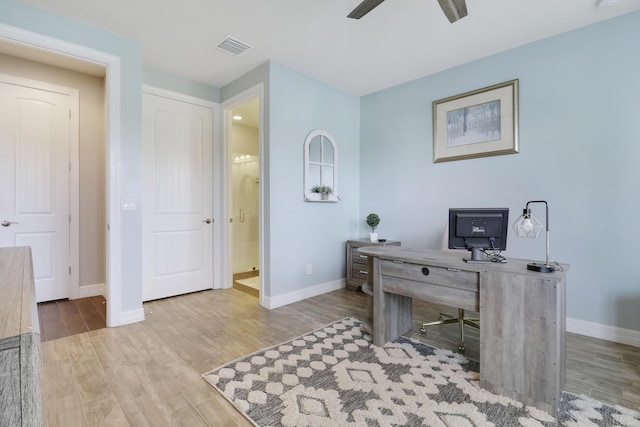 home office featuring light hardwood / wood-style floors and ceiling fan