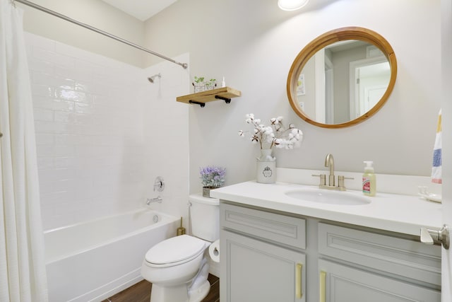 full bathroom featuring vanity, hardwood / wood-style floors, shower / tub combo, and toilet