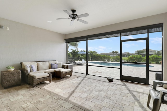 sunroom / solarium with a healthy amount of sunlight and ceiling fan