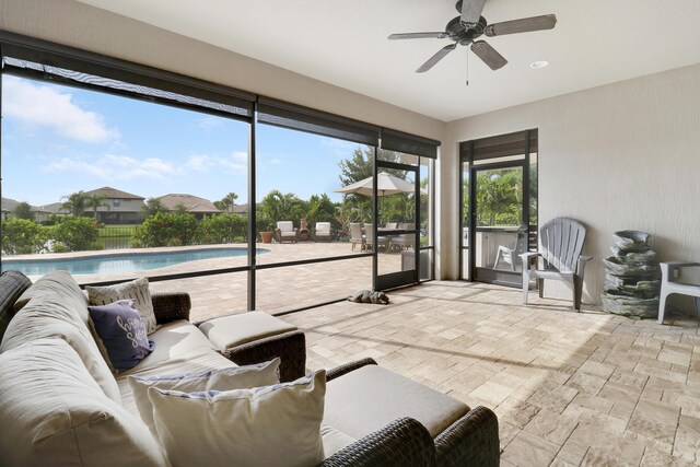 sunroom / solarium featuring ceiling fan