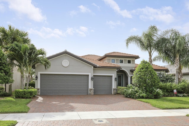 mediterranean / spanish-style house with a garage