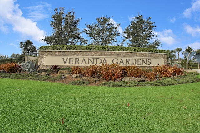 community sign featuring a lawn