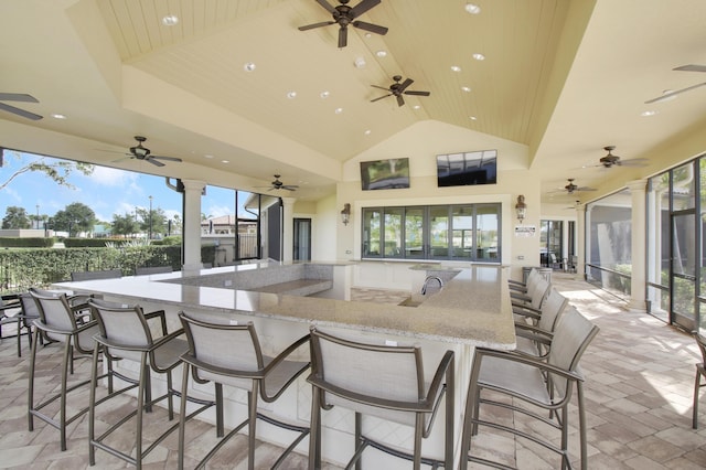 view of patio / terrace featuring ceiling fan and an outdoor bar