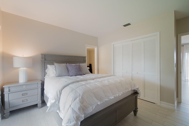 bedroom featuring a closet and light wood-type flooring