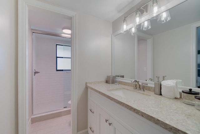 bathroom with vanity, tile patterned floors, walk in shower, and toilet