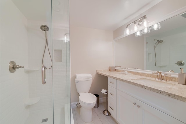 bathroom featuring vanity, toilet, a shower with door, and tile patterned flooring