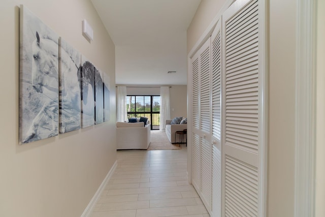 hallway featuring light colored carpet