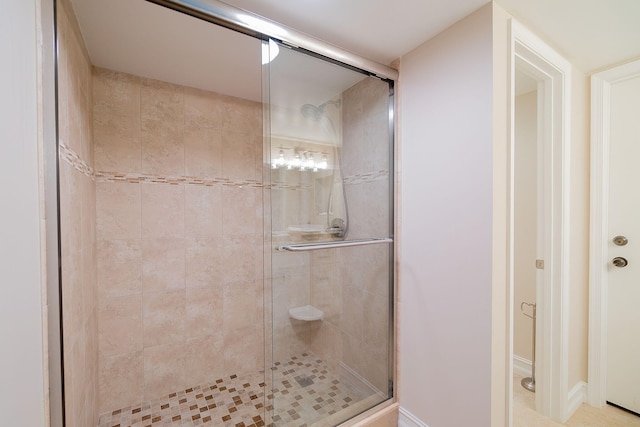 bathroom with a shower with shower door