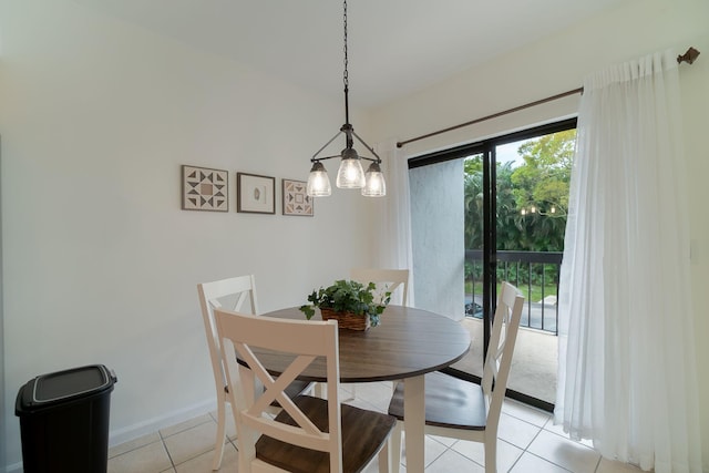 dining space with an inviting chandelier and light tile patterned floors