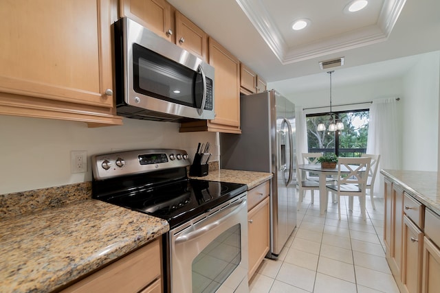 kitchen with a notable chandelier, light tile patterned floors, a tray ceiling, light stone countertops, and appliances with stainless steel finishes