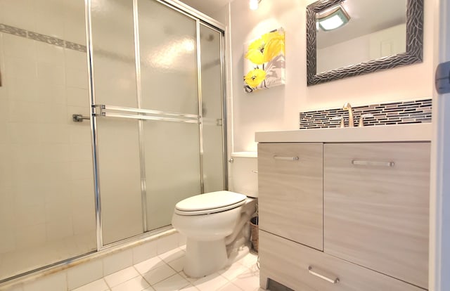 bathroom featuring tile patterned flooring, vanity, an enclosed shower, and toilet