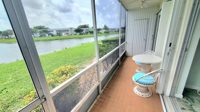 sunroom / solarium featuring a water view and a healthy amount of sunlight