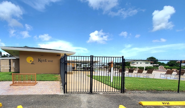 view of gate with a yard