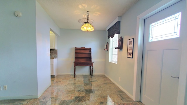 hallway with a notable chandelier