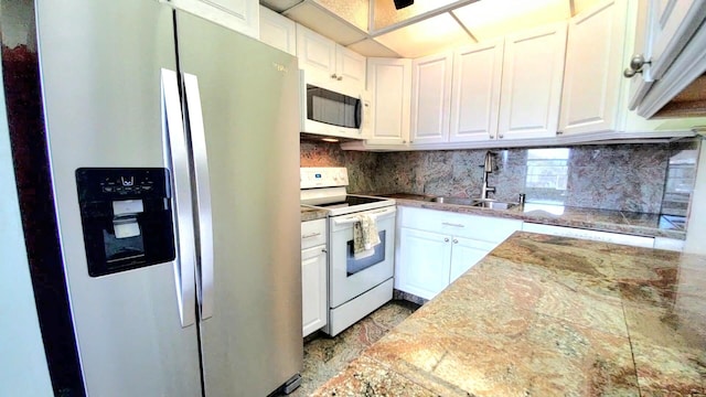 kitchen with white cabinetry, sink, and white appliances