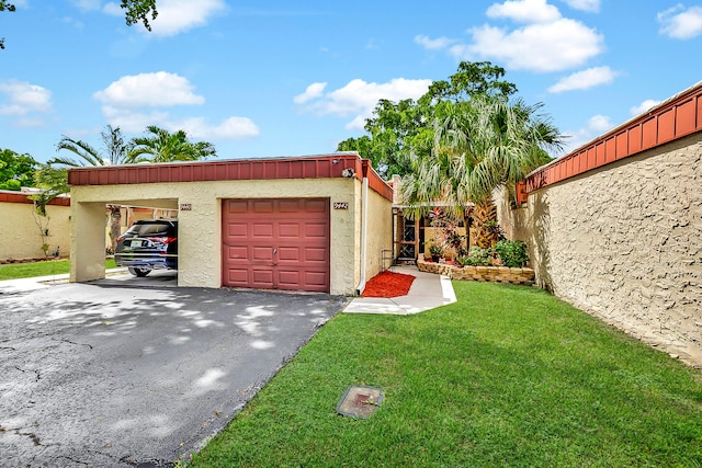 exterior space featuring a carport, a garage, and a lawn