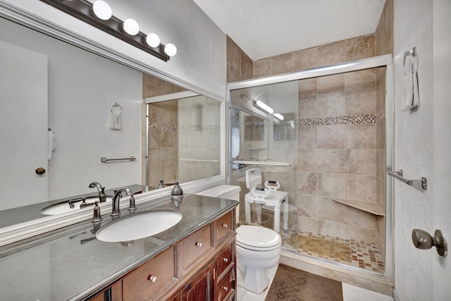 bathroom featuring vanity, a shower with shower door, toilet, and tile patterned floors