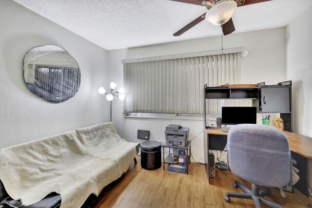 office with a textured ceiling, ceiling fan, and hardwood / wood-style floors