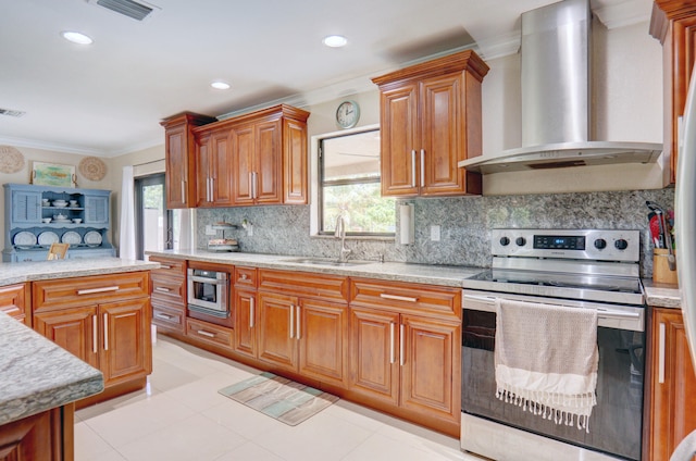 kitchen featuring stainless steel appliances, crown molding, a healthy amount of sunlight, and wall chimney range hood