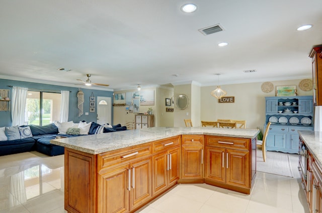 kitchen featuring light stone countertops, crown molding, light tile patterned floors, decorative light fixtures, and a kitchen island