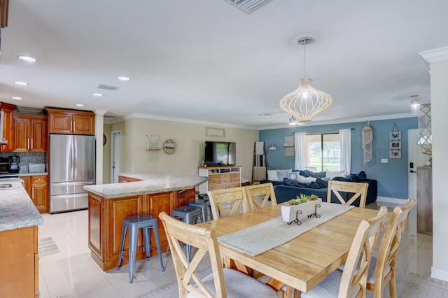 tiled dining room featuring crown molding and a notable chandelier