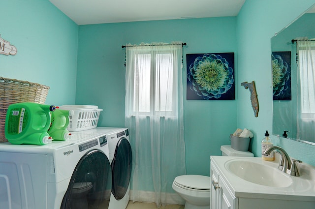 washroom featuring separate washer and dryer and sink