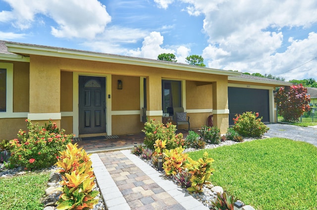 ranch-style house featuring covered porch and a garage