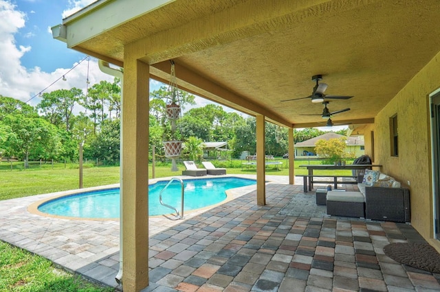 view of pool with a lawn, ceiling fan, and a patio