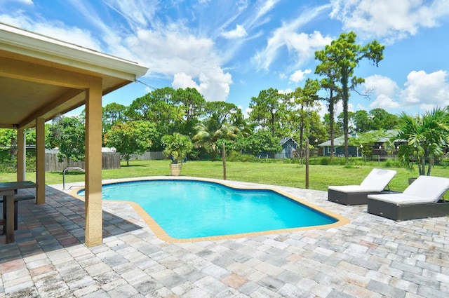 view of pool with a lawn and a patio area