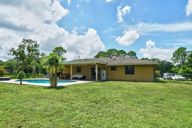 back of house featuring a yard and a patio