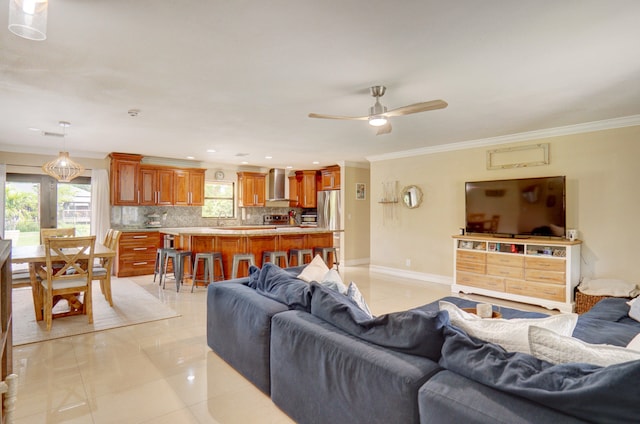 tiled living room with ceiling fan and ornamental molding