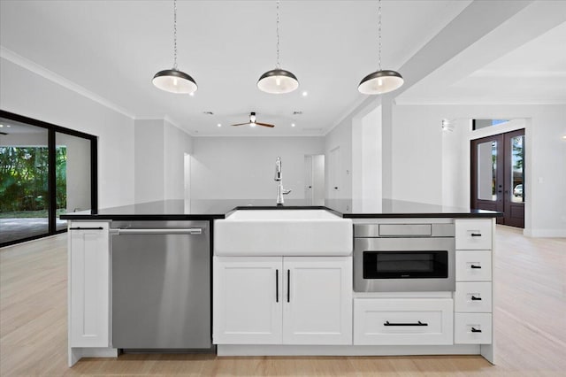 kitchen with white cabinets, stainless steel appliances, and light hardwood / wood-style floors