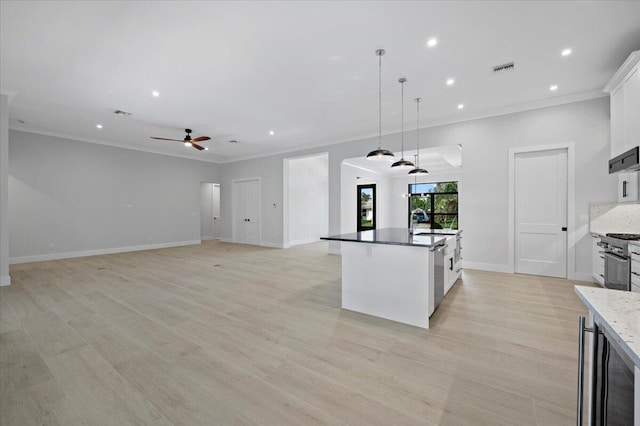 kitchen with white cabinetry, light hardwood / wood-style flooring, ceiling fan, and hanging light fixtures