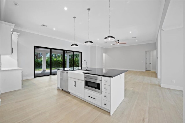 kitchen featuring pendant lighting, sink, dishwasher, an island with sink, and white cabinets