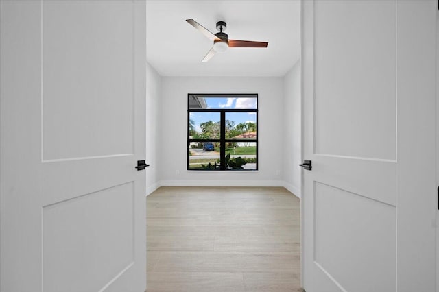 empty room with light wood-type flooring and ceiling fan