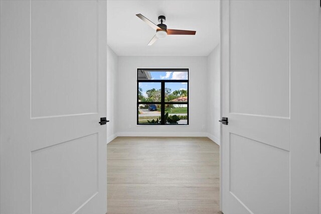 empty room featuring ceiling fan and light wood-type flooring