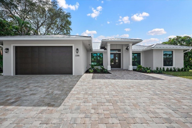 view of front of house featuring a garage and french doors