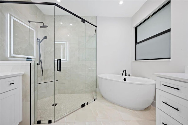 bathroom featuring vanity and independent shower and bath