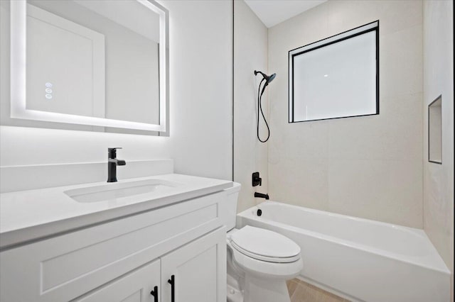 full bathroom featuring vanity, tiled shower / bath, and toilet