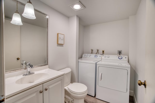 bathroom featuring vanity, toilet, and independent washer and dryer