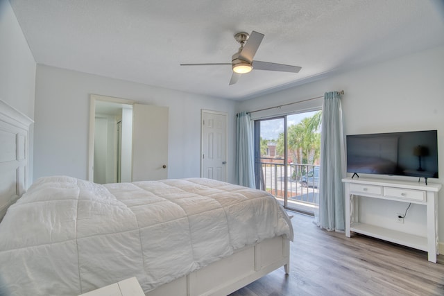 bedroom with access to exterior, ceiling fan, and wood-type flooring