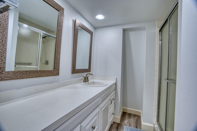 bathroom with vanity, wood-type flooring, and walk in shower