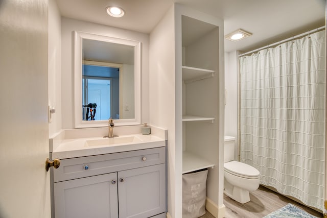 bathroom featuring hardwood / wood-style floors, vanity, and toilet