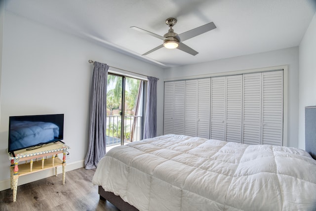 bedroom with access to outside, ceiling fan, hardwood / wood-style floors, and a closet