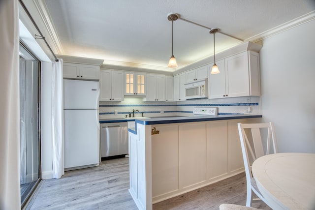 kitchen featuring sink, white cabinetry, white appliances, and light hardwood / wood-style floors