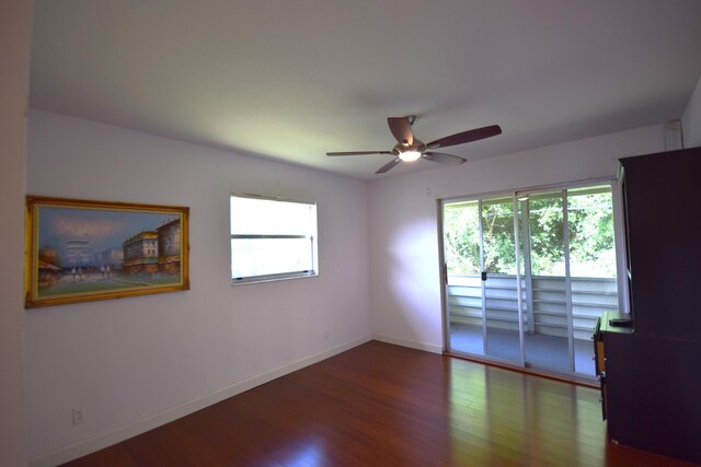 empty room with ceiling fan and hardwood / wood-style floors