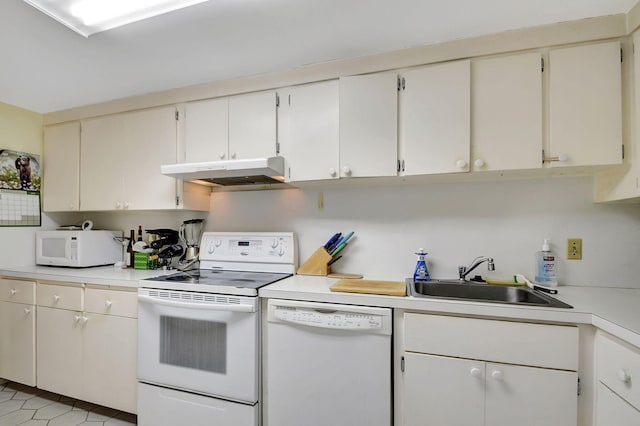 kitchen featuring light tile patterned flooring, white cabinetry, white appliances, and sink