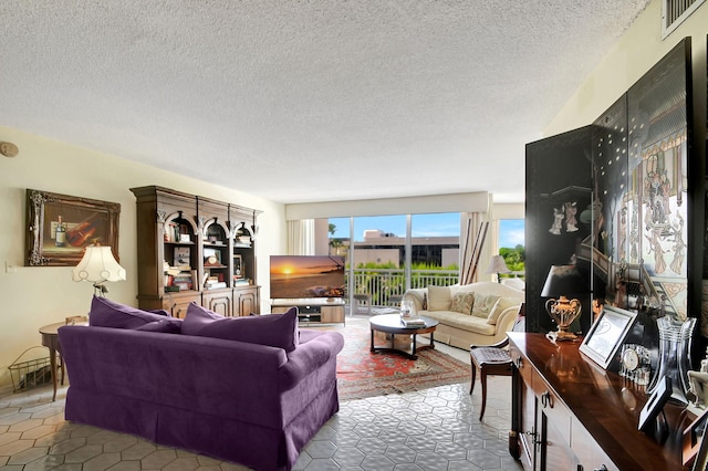 living room featuring tile patterned flooring and a textured ceiling