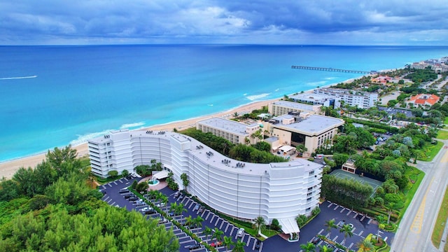 aerial view featuring a water view, a view of city, and a view of the beach